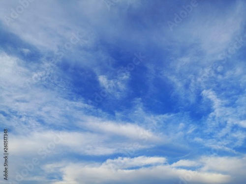 blue sky with white, soft clouds.The sky is clear.