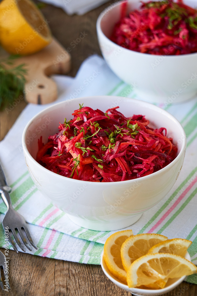 Vegetable salad with beets, cabbage and carrots in a white bowl Vegetable salad with beets, cabbage and carrots in a white bowl