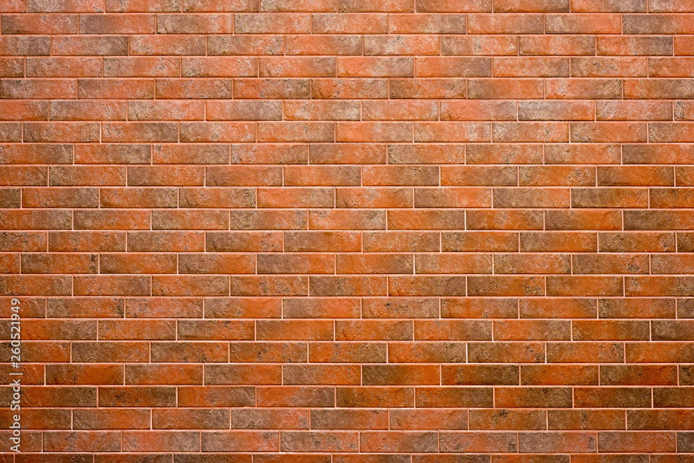 Obraz premium The wall is lined with red brick tiles.