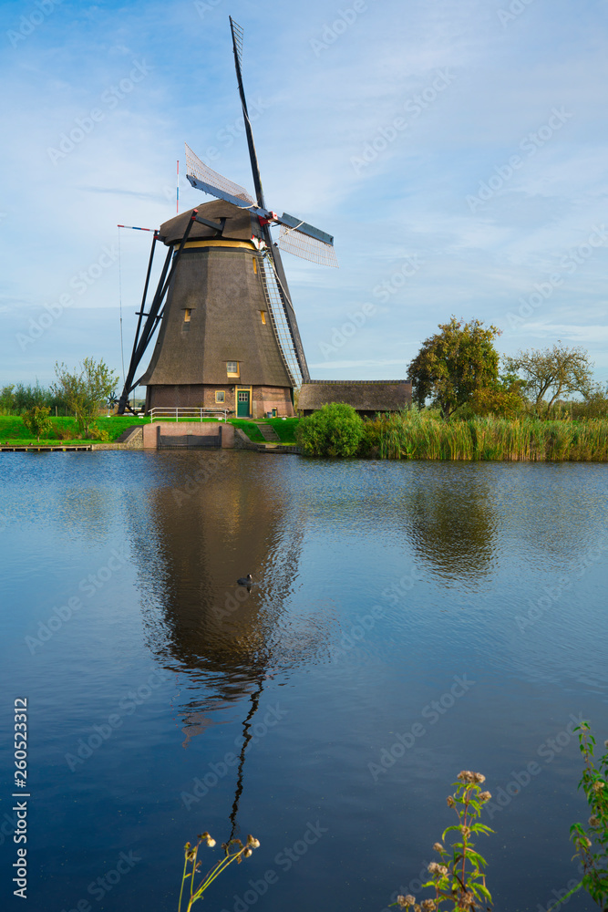 Mill with reflection in river Alblas in Kinderdijk, The Netherlands. Unesco place. Copy space