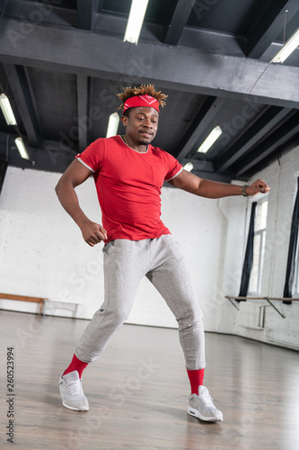 Contented African American short-haired guy having run-through