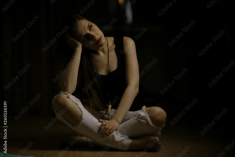 Fototapeta premium Studio portrait of a beautiful brunette on a black background