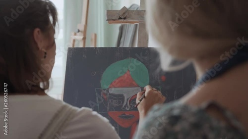 Art couch, painting and hands closeup. Female student and fenale artist in a studio photo