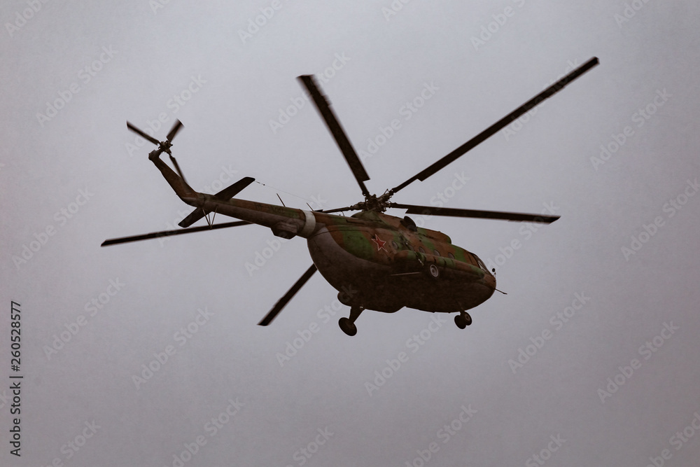 Fototapeta premium Mi-8 helicopters in the cloudy sky