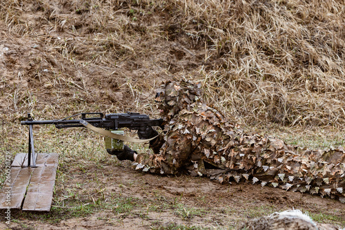 Machine gunner in combat position photo