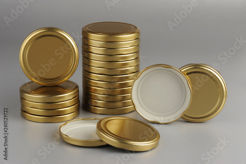 Screw caps for glass jars. For canning, canned food. Golden caps on gray background