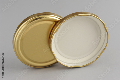 Screw caps for glass jars. For canning, canned food. Golden caps on gray background