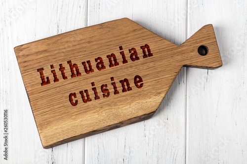 Wooden cutting board with inscription. Concept of lithuanian cuisine