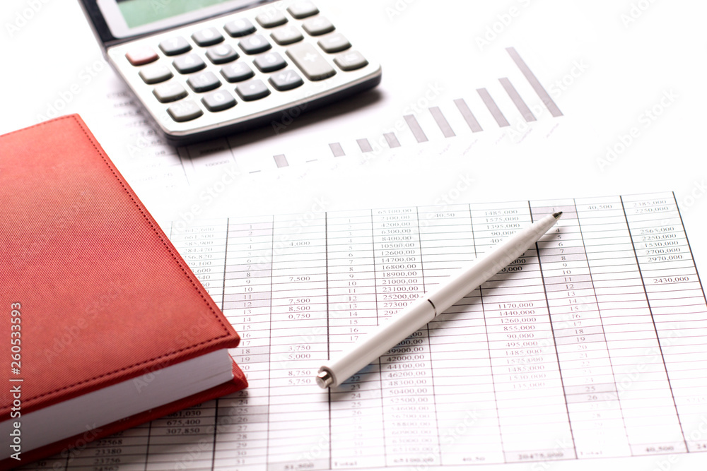 Accountant work table with calculator, charts and pen. Accountant work table with calculator, charts and pen.