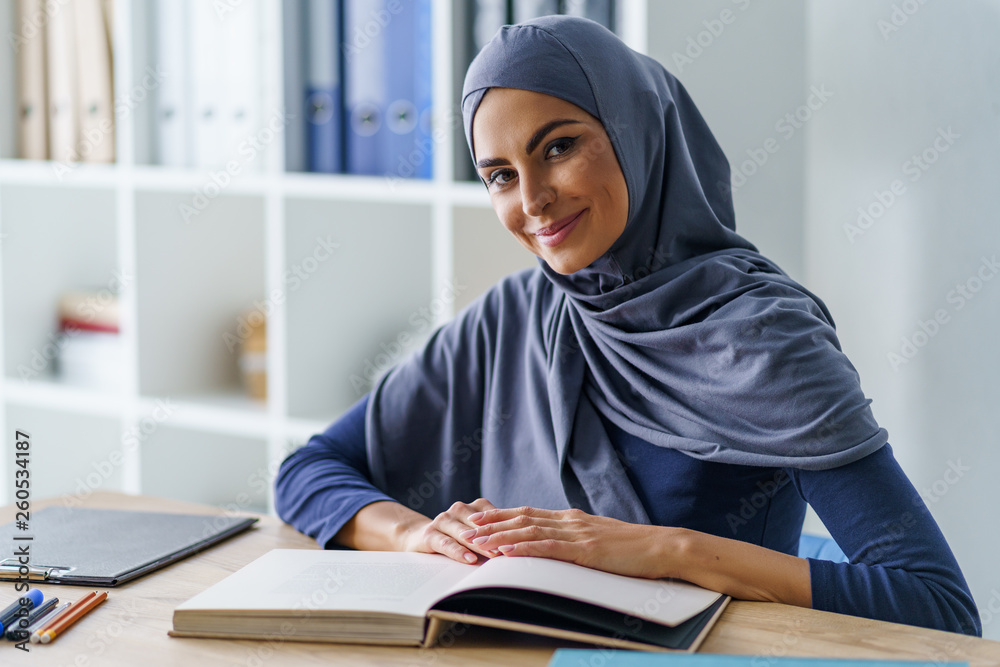 Female teacher sitting at desk Female teacher sitting at desk