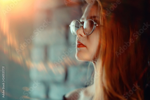 red-haired happy girl wearing glasses / business woman concept, confident, successful girl with glasses. Sight, training, European business.