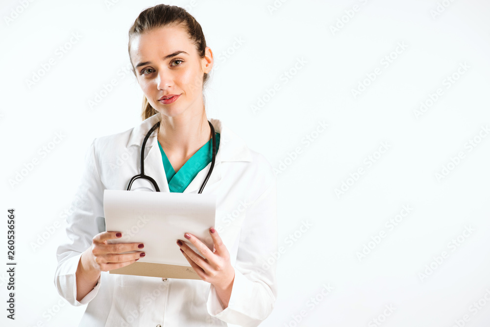 Young nurse with stethoscope and papers in her scrub uniform. Young nurse with stethoscope and papers in her scrub uniform.