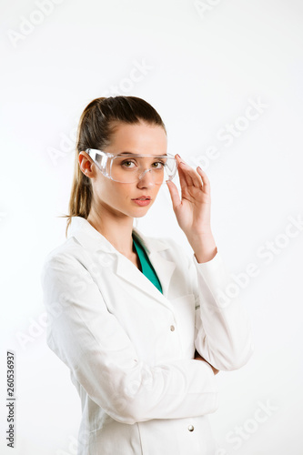 Young nurse wearing lab glasses.