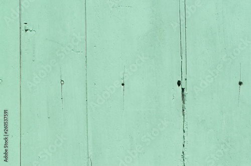 Faded green or blue wooden background with some cracked spots and vertical pattern on it