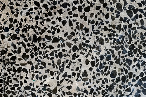 Abstract background. White concrete marble floor with black stone chips. Smooth polished surface