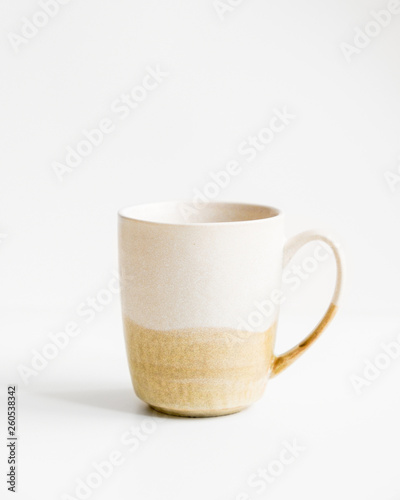 New yellow mug with lines on isolated white background.