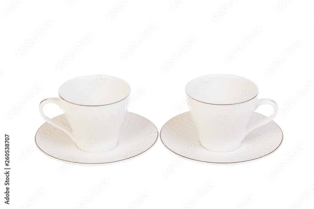 Two white porcelain tea, coffee cups with saucer. Isolated on white Two white porcelain tea, coffee cups with saucer. Isolated on white