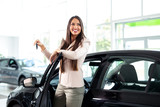 Young happy woman near the car with keys in hand - buying new car