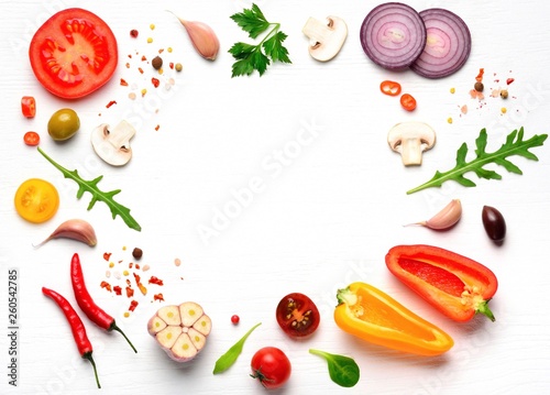 Organic fresh vegetables and spices frame on wooden white background. Copyspace, top view. 