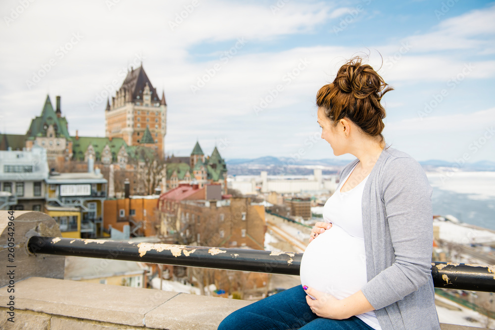 Pregnant girl outside on a city background