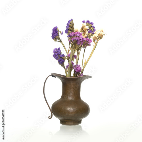 Brass vase with dry flowers isolated on white background