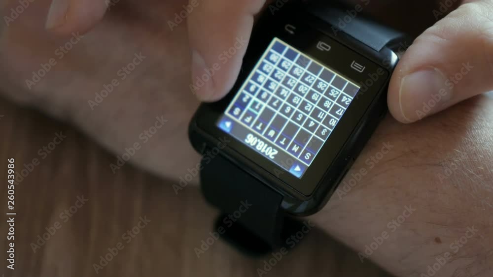 Man Using Calendar App Smart Watch to Check Schedule. Close up. Businessman using a calendar application on a smartwatch connected device. Closeup. Man Using Calendar App Smart Watch to Check Schedule. Close up. Businessman using a calendar application on a smartwatch connected device. Closeup.