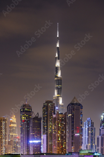 Stunning view of the illuminated Dubai skyline during sunset with the magnificent Burj Khalifa and many other buildings, skyscrapers and towers. Dubai, United Arab Emirates. 