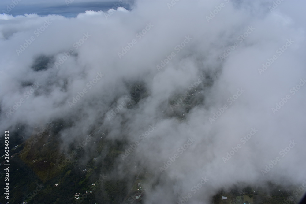 Arial view of Hilo Hawaii from above the clouds. Tourism showing the city from a helicopter