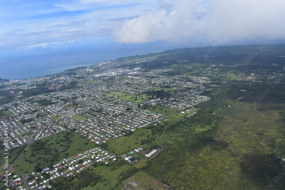 Arial view of Hilo Hawaii from a helicopter urban city seen from above the clouds Tourist location