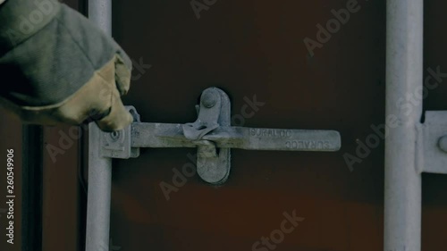 Cutting seal from a freight container. Work in the port. Port workers.