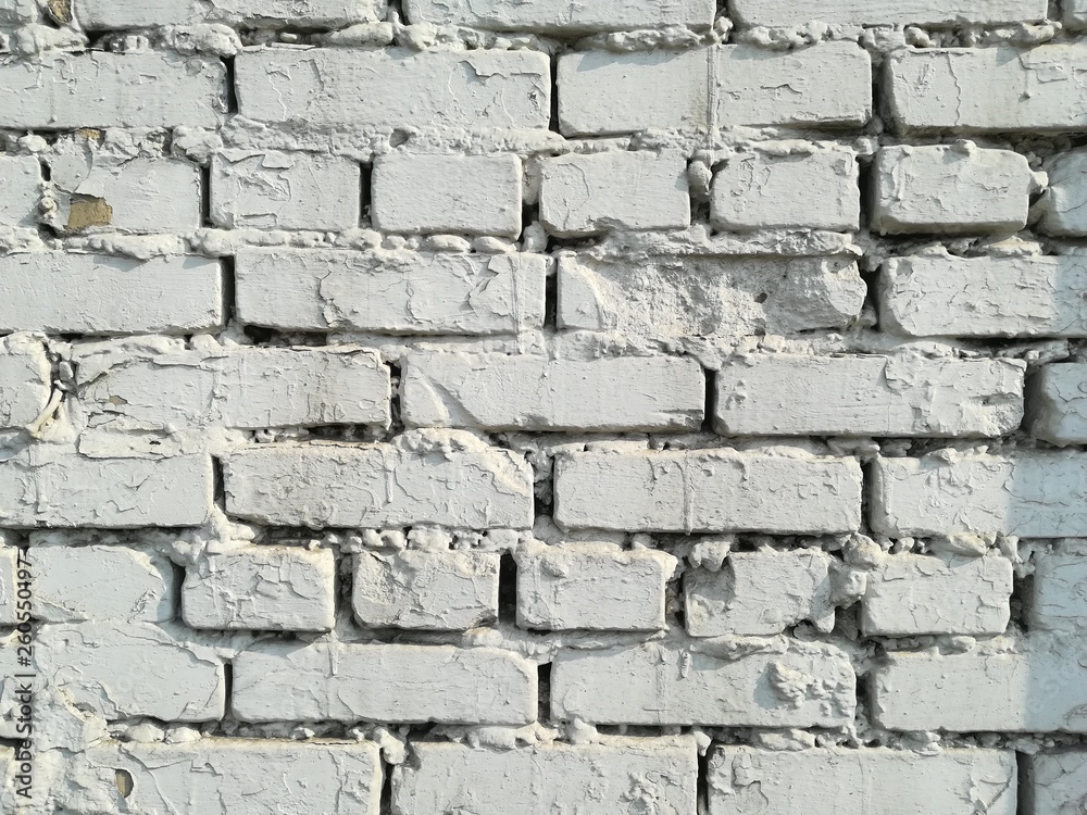 Textured abstract background old brick white wall dirty vintage in  sunny day