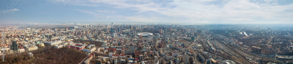 Panoramic aerial view from drone. on the city of Kiev with a railway and a stadium in the distance against the sky.