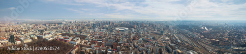 Panoramic aerial view from drone. on the city of Kiev with a railway and a stadium in the distance against the sky.