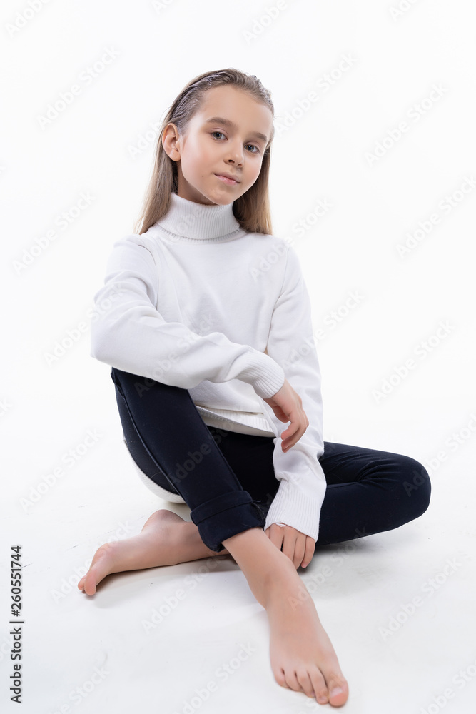 Beautiful cute teen girl wearing a white turtleneck sweater and