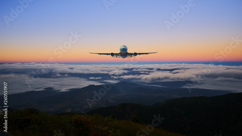 airplane on the skyline and sunrise landscape cloud and hill