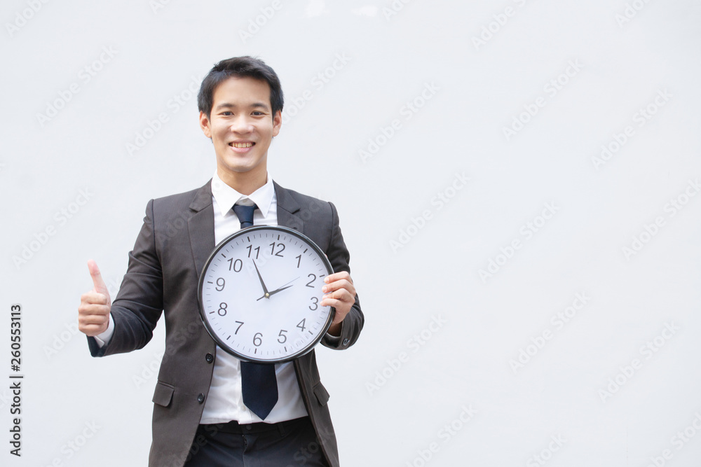 Asian man with clock,business time, business time management,start up business. Asian man with clock,business time, business time management,start up business.