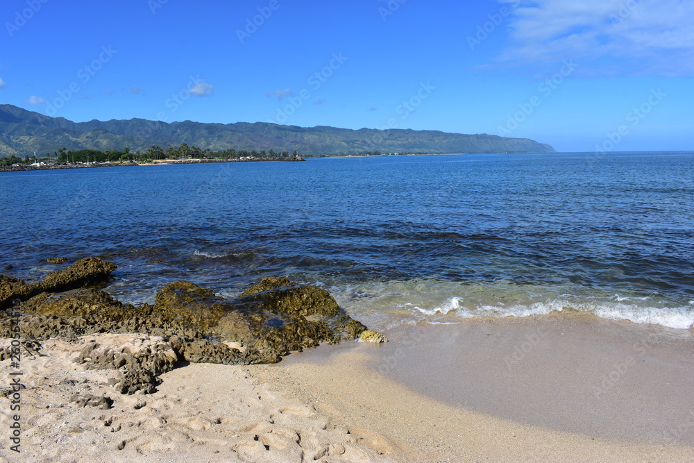 Mountains along the Pacific Ocean. Dense jungle growing around and up the steep slopes under a beautiful blue sky Mountains along the Pacific Ocean. Dense jungle growing around and up the steep slopes under a beautiful blue sky