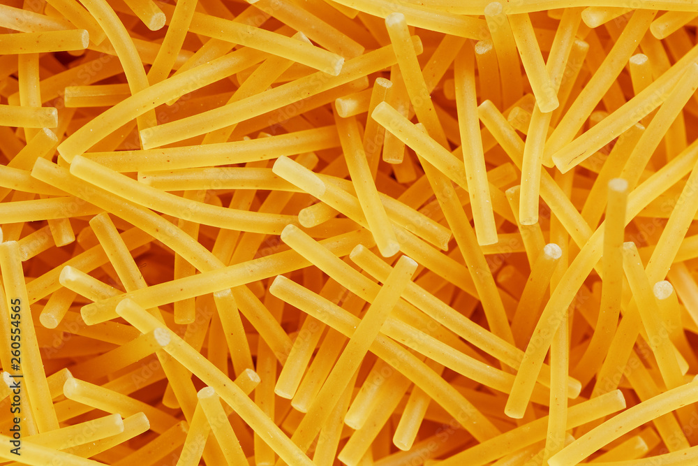 Background texture and pattern of boiled egg noodles or spaghetti pasta in full-frame format. View from above. Close-up Background texture and pattern of boiled egg noodles or spaghetti pasta in full-frame format. View from above. Close-up