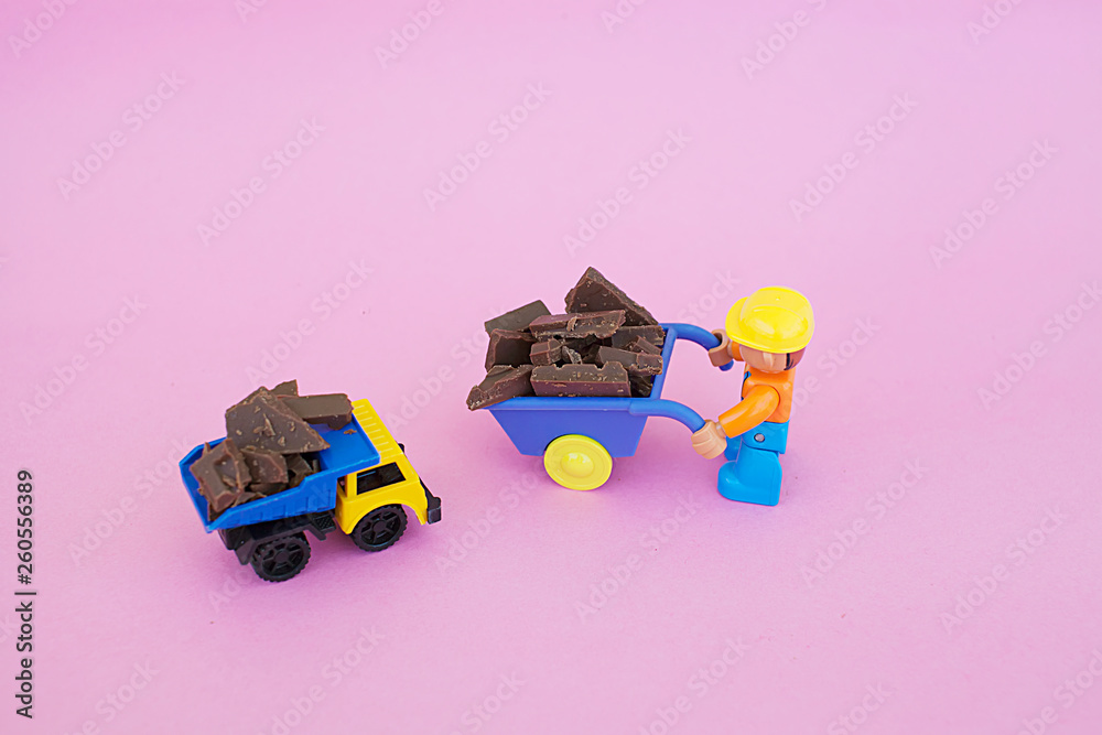 Obraz premium chocolate, pieces and toys of chocolate lie on a bright background, bright candy. white and black chocolate. ..