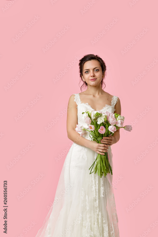 beautiful bride with wedding bouquet of pink tulips on pink background beautiful bride with wedding bouquet of pink tulips on pink background