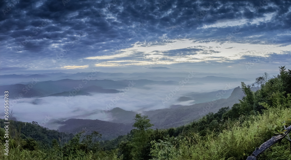 Mountain view morning of the hills around with sea of mist cover with cloudy sky background, sunrise at Doi Samur Dao, Sri Nan National Park, Nan, Thailand.