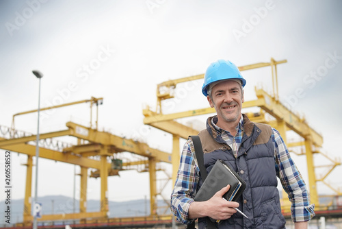 Construction worker on industrial sight looking at camera
