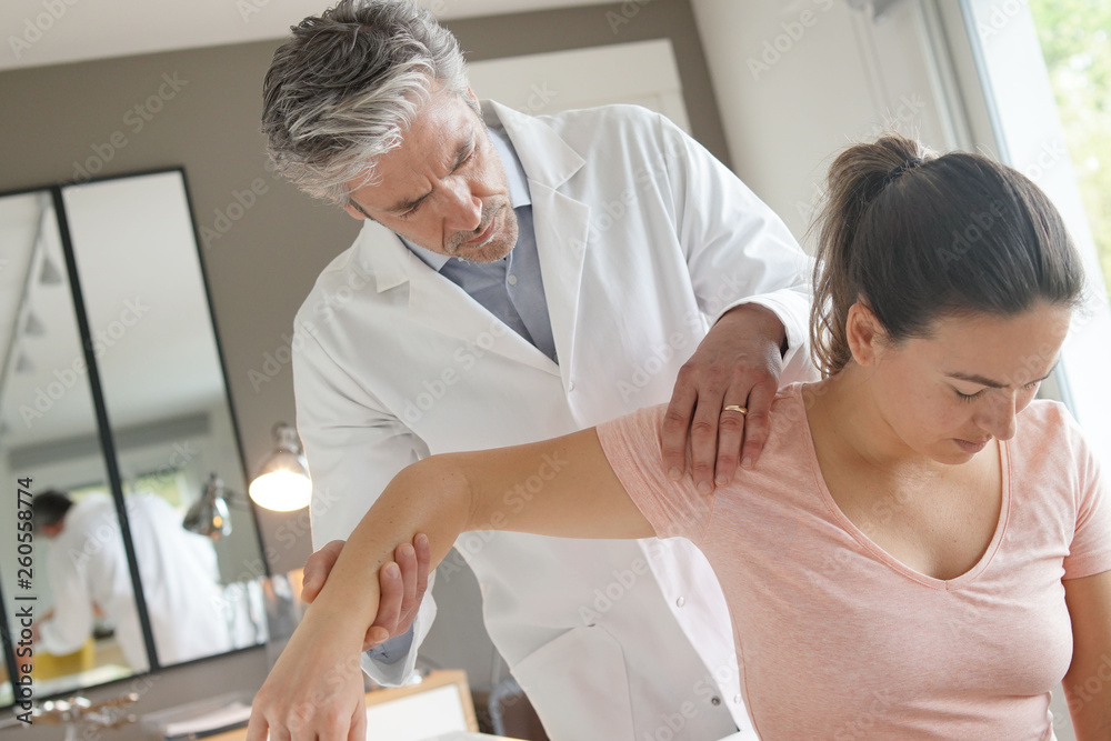 Physiotherapist helping patient with shoulder injury Physiotherapist helping patient with shoulder injury