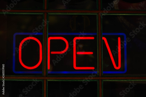 Neon red sign with the word open.