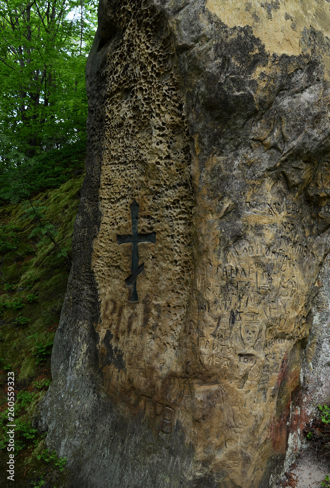 The stone walls of the ancient castle on a background of blue sky and