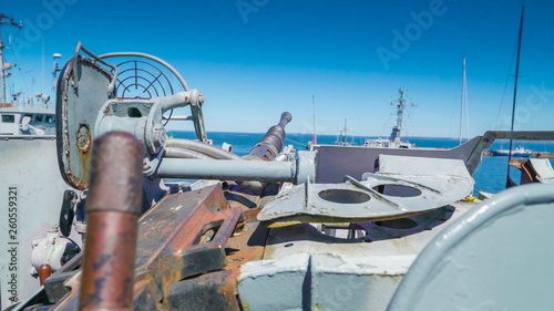 The rusty ammunitions on the top of the deck of the ship