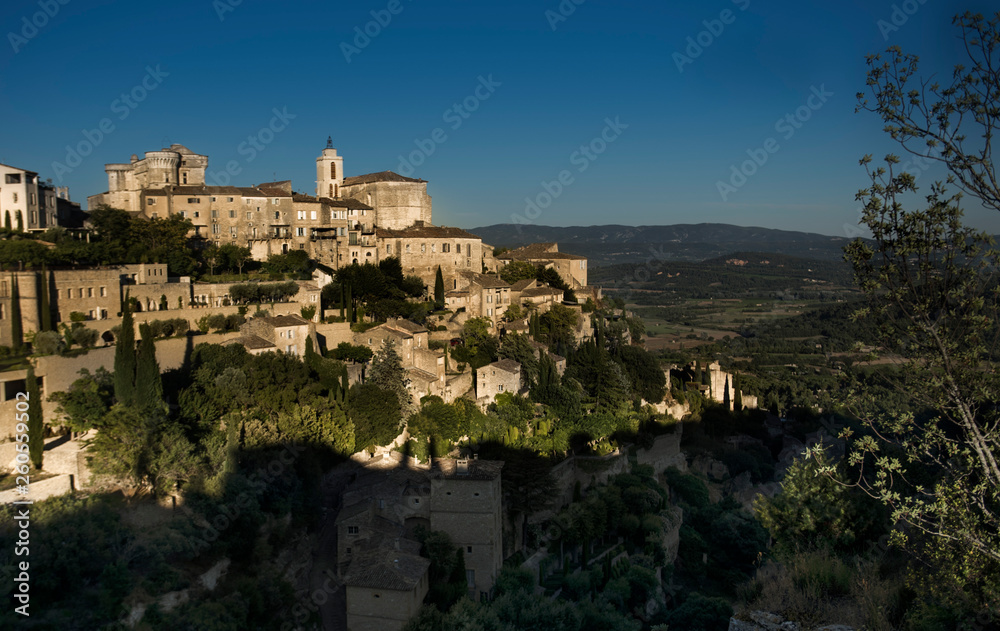 medieval village perched on the hill in the warm light of sunset