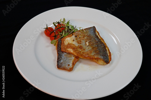 Fototapeta Naklejka Na Ścianę i Meble -  pan fried sea bass in a white plate