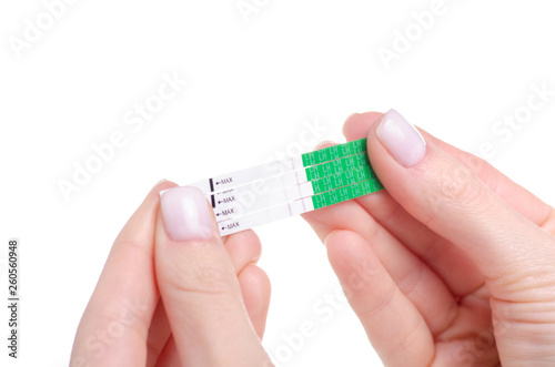 Принти на полотні Ovulation tests positive in hand on a white background. Isolation