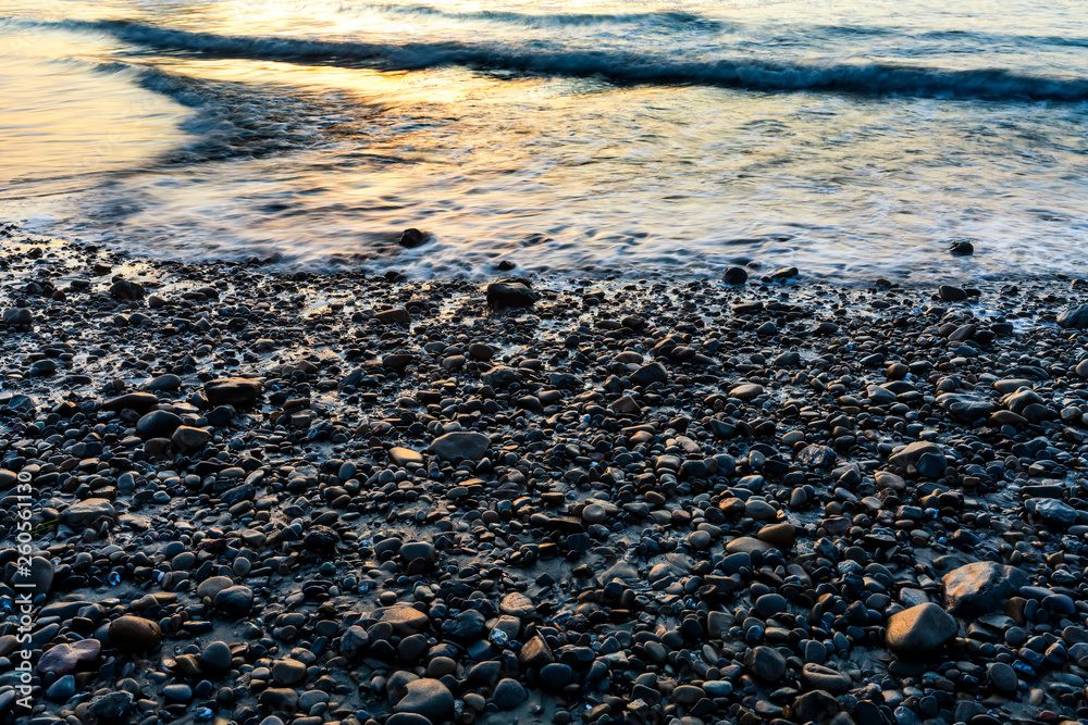 Waves and Rocks on Beach at Dusk Waves and Rocks on Beach at Dusk